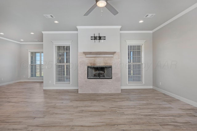 unfurnished living room with baseboards, visible vents, ceiling fan, and a fireplace
