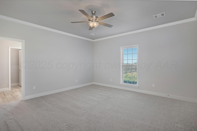 unfurnished room with light carpet, visible vents, crown molding, and a ceiling fan