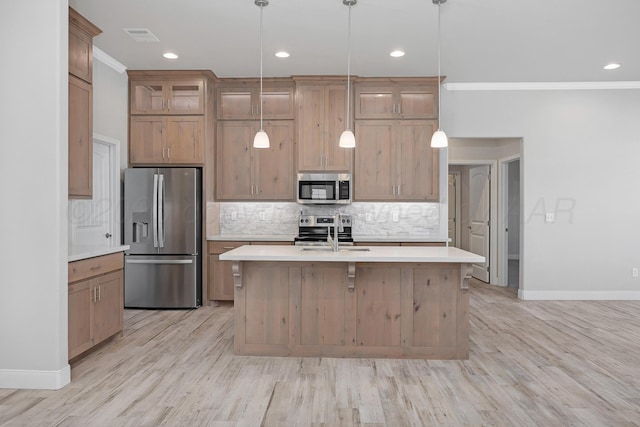 kitchen with light countertops, tasteful backsplash, and appliances with stainless steel finishes