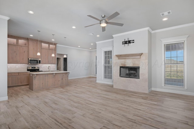 kitchen with decorative backsplash, light countertops, visible vents, appliances with stainless steel finishes, and open floor plan