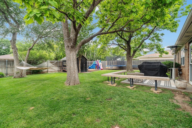 3313 Burrus Pl, Amarillo, TX 79121 - fenced backyard with a trampoline, a playground, a patio area, and a shed