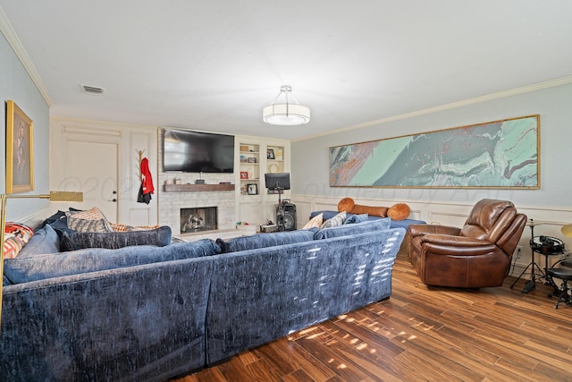 3313 Burrus Pl, Amarillo, TX 79121 - living room with ornamental molding, a fireplace, wood finished floors, built in features, and wainscoting