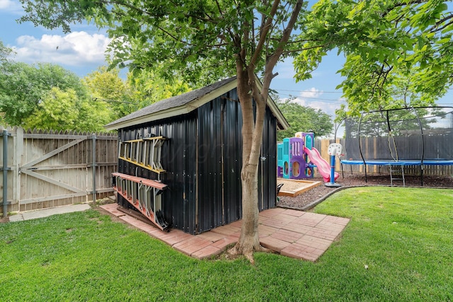 3313 Burrus Pl, Amarillo, TX 79121 - view of shed featuring a trampoline, a fenced backyard, and a gate