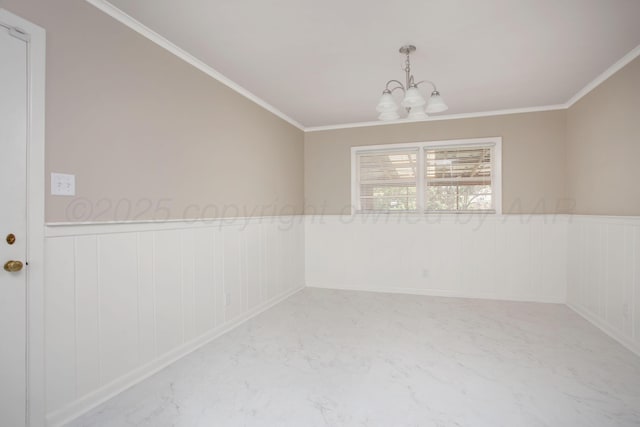 5214 George Ter, Amarillo, TX 79106 - empty room featuring a chandelier, a wainscoted wall, crown molding, a decorative wall, and marble finish flooring
