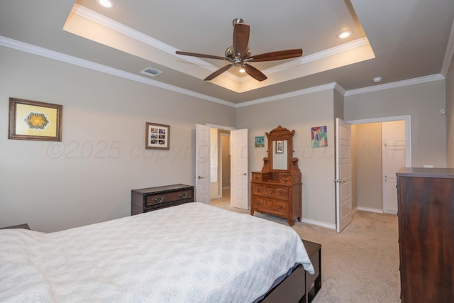 bedroom featuring a tray ceiling, light carpet, ornamental molding, baseboards, and a ceiling fan
