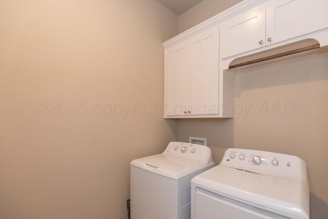laundry room with cabinet space and washer and clothes dryer