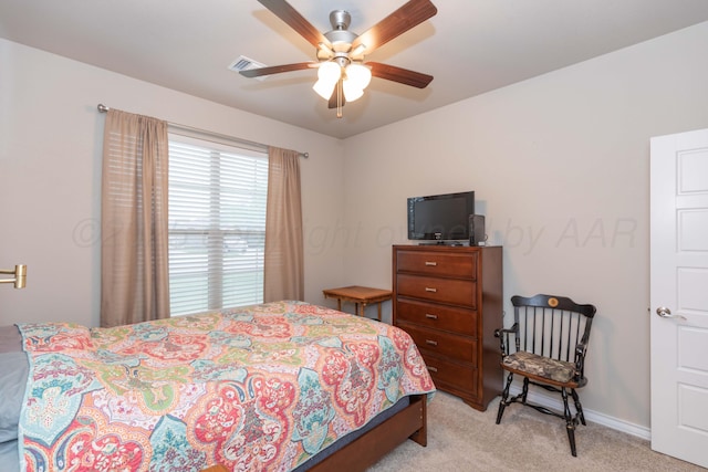 bedroom featuring light carpet, baseboards, and a ceiling fan