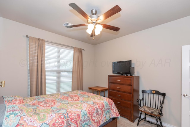 bedroom with light carpet, ceiling fan, and baseboards
