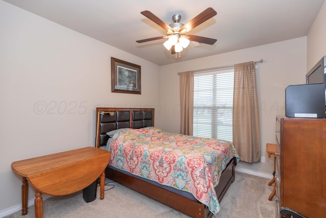 bedroom with light carpet, baseboards, and a ceiling fan