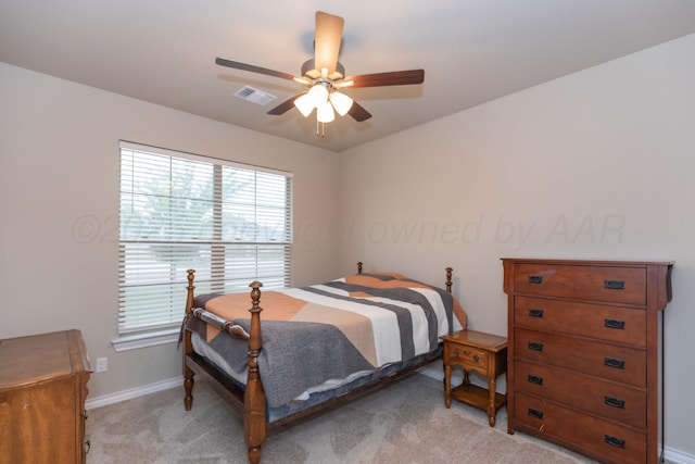bedroom with light carpet, baseboards, and a ceiling fan