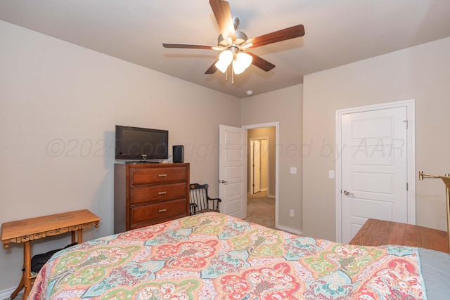 bedroom with a ceiling fan, carpet, and baseboards