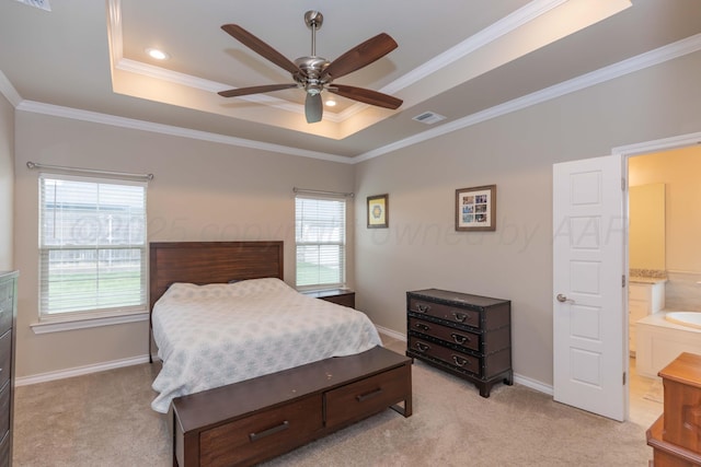 bedroom with a raised ceiling, light colored carpet, crown molding, baseboards, and ceiling fan