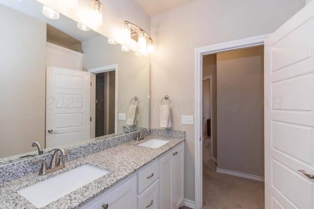 full bathroom with double vanity and baseboards