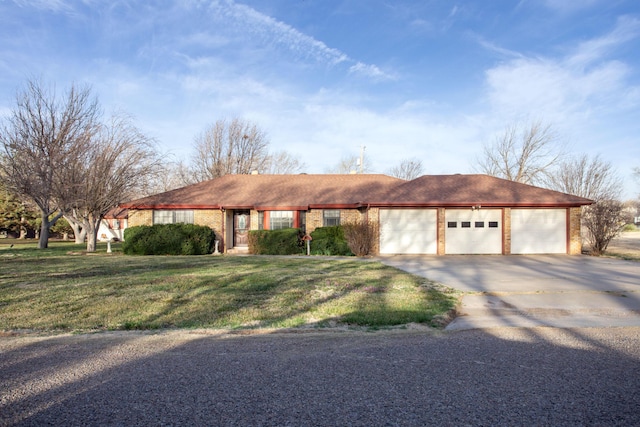 view of front of property with brick siding, concrete driveway, a garage, and a front yard