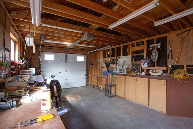 garage featuring a workshop area and a garage door opener