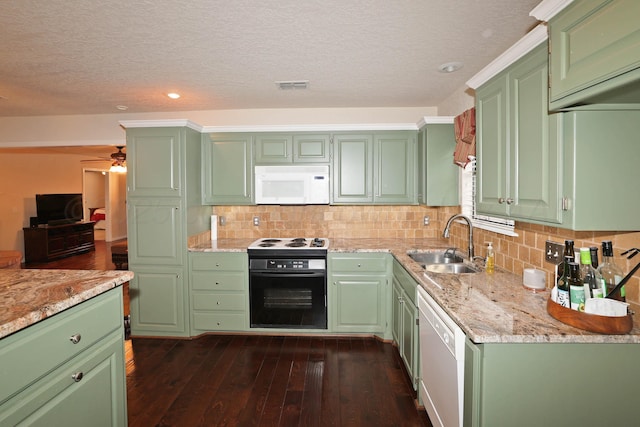 kitchen with white appliances, a sink, light stone countertops, backsplash, and recessed lighting