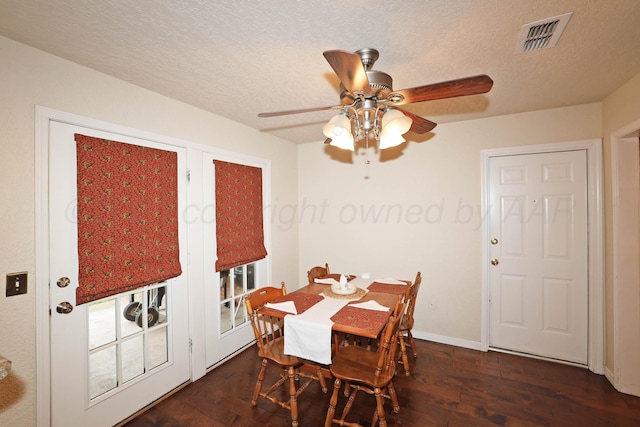 dining area with dark wood finished floors, ceiling fan, baseboards, and a textured ceiling