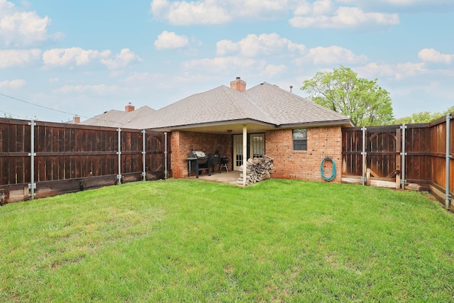 back of house featuring roof with shingles, brick siding, and a patio area
