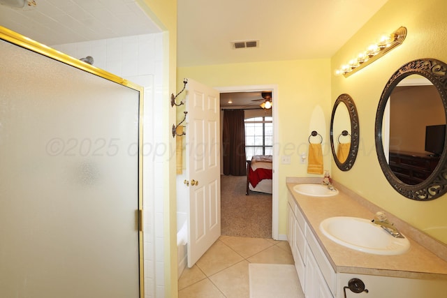 ensuite bathroom with tile patterned flooring, a stall shower, a ceiling fan, and double vanity