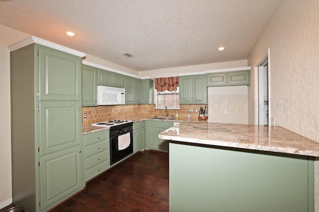 kitchen featuring white microwave, green cabinets, electric range, a sink, and a textured ceiling