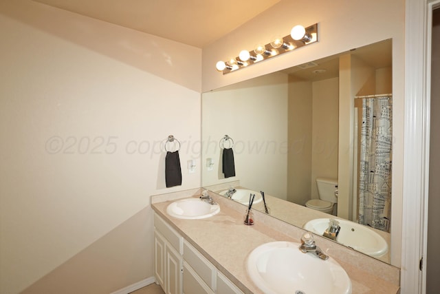 bathroom with toilet and double vanity