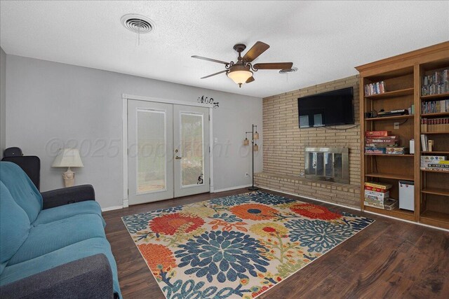 5021 Westway Trl, Amarillo, TX 79109 - living room with french doors, a ceiling fan, wood finished floors, a brick fireplace, and baseboards