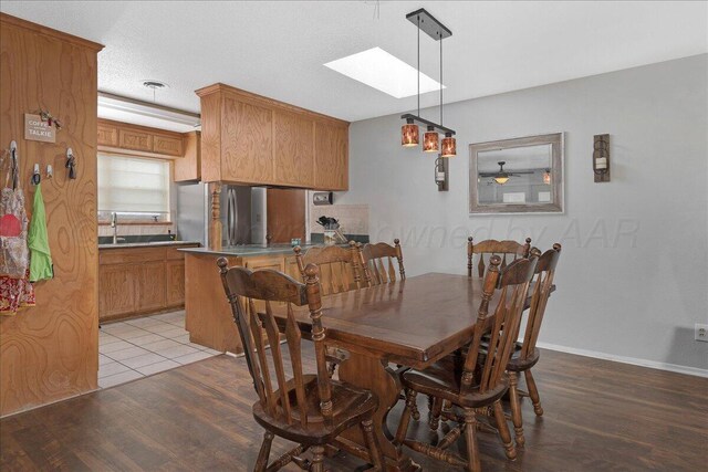 5021 Westway Trl, Amarillo, TX 79109 - dining space featuring a skylight, light wood finished floors, and baseboards