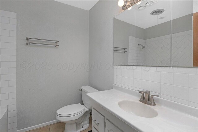 5021 Westway Trl, Amarillo, TX 79109 - full bathroom featuring toilet, vanity, baseboards, and tile patterned flooring
