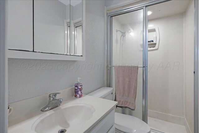 5021 Westway Trl, Amarillo, TX 79109 - full bathroom with toilet, a stall shower, vanity, and a textured wall