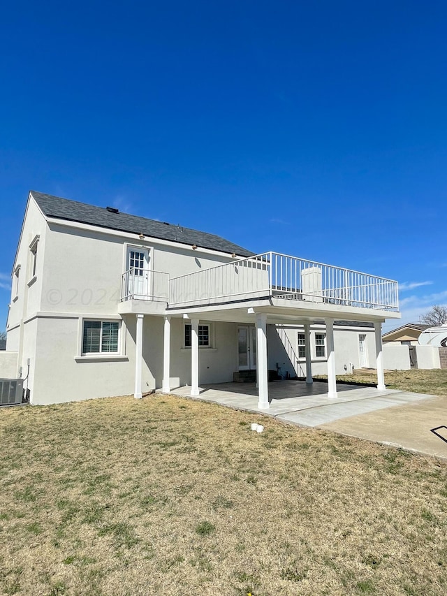 rear view of house featuring central AC unit, a patio area, a yard, and a wooden deck