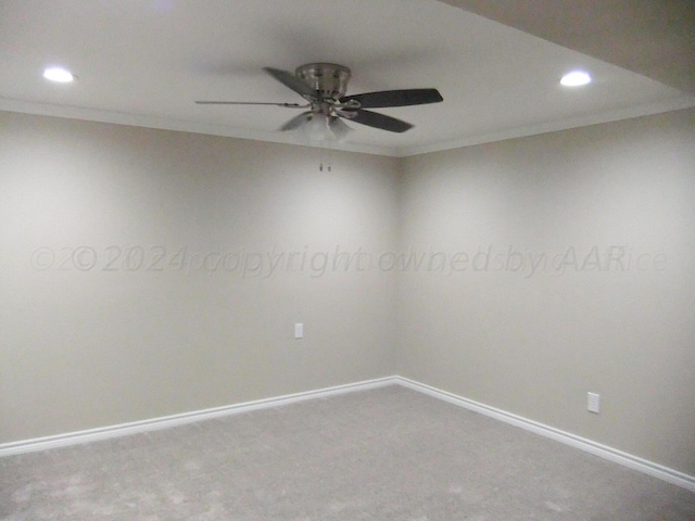 carpeted spare room with ceiling fan and ornamental molding