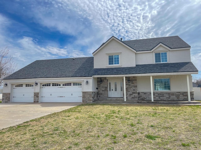 view of front property featuring a garage, a front yard, and a porch