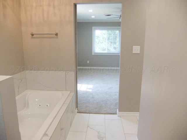 bathroom featuring a bath, ceiling fan, and crown molding