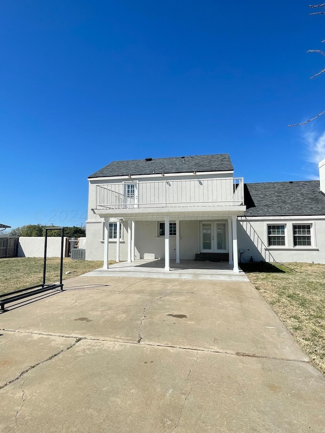 rear view of property featuring a yard