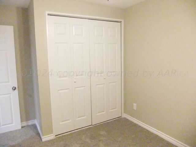 unfurnished bedroom featuring a closet and carpet floors