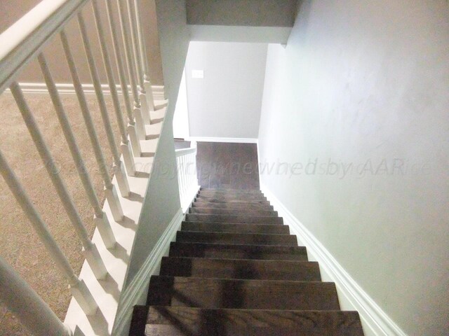 stairs featuring wood-type flooring