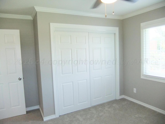 unfurnished bedroom featuring multiple windows, light carpet, ceiling fan, and crown molding