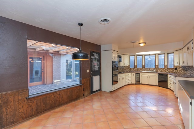 6011 Hatfield Cir, Amarillo, TX 79109 - kitchen with black appliances, backsplash, dark countertops, decorative light fixtures, and light tile patterned floors