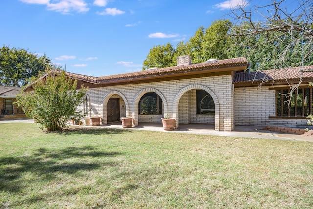 rear view of house featuring a yard