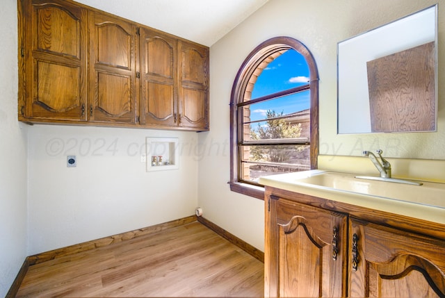 laundry room with cabinets, sink, washer hookup, hookup for an electric dryer, and light hardwood / wood-style floors