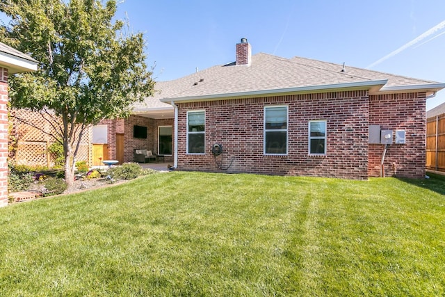 6400 Glenwood Dr, Amarillo, TX 79119 - rear view of house featuring brick siding, a chimney, a shingled roof, and a patio