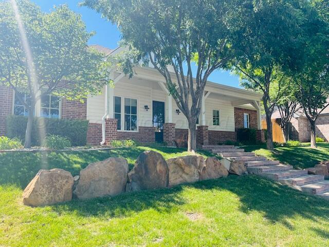 6400 Glenwood Dr, Amarillo, TX 79119 - view of front of home with brick siding and a front lawn