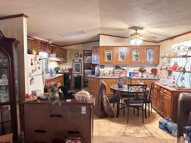 kitchen with vaulted ceiling, white refrigerator, a textured ceiling, black range with gas cooktop, and ceiling fan