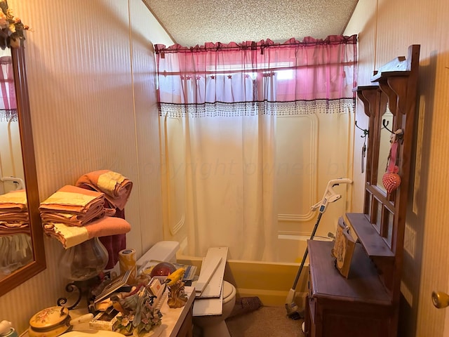 bathroom with toilet, shower / tub combo with curtain, lofted ceiling, and a textured ceiling