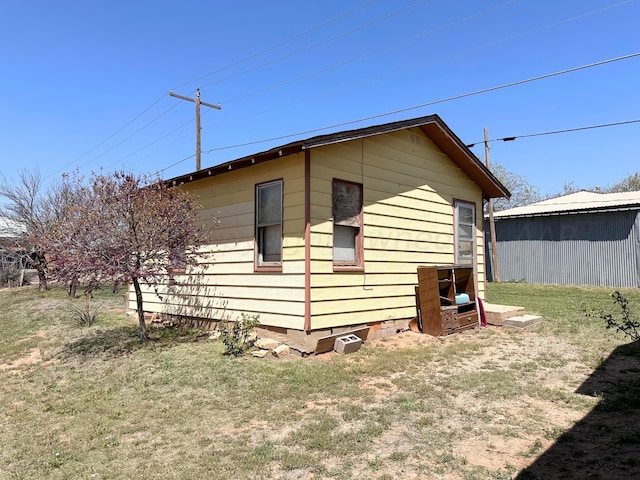 view of side of property with a lawn