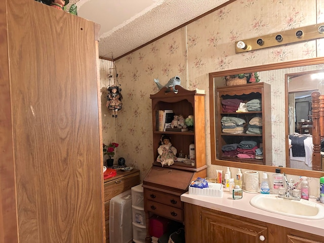 bathroom with vanity and a textured ceiling