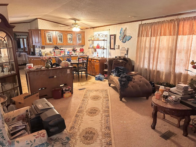 living room with ceiling fan, a textured ceiling, light carpet, and lofted ceiling