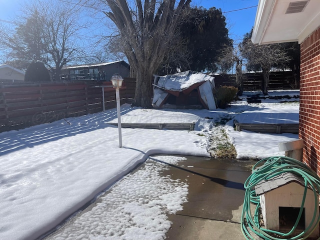 view of yard layered in snow