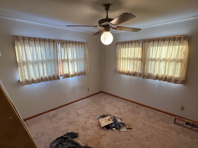 carpeted empty room with ceiling fan