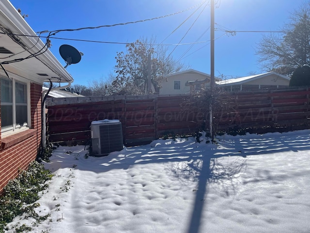 snowy yard with central AC